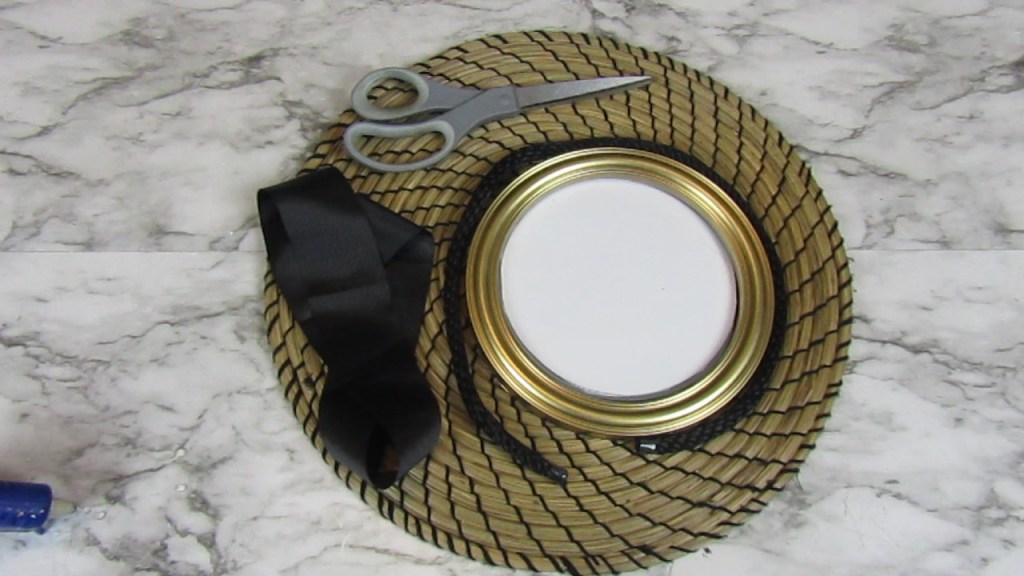 DIY Placemat Wall Decor - IKEA seagrass placemat, dollar tree mirror, ribbon, braided rope and a pair of scissor.